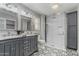 This bathroom has a double sink vanity with a glass shower enclosure and lovely tile at 12703 W Shadow Hills Dr, Sun City West, AZ 85375