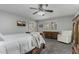 Comfortable bedroom featuring a TV, ceiling fan and charming decor at 12703 W Shadow Hills Dr, Sun City West, AZ 85375