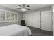 This bedroom features a fan, window with shutters, closet, and a chair at 12703 W Shadow Hills Dr, Sun City West, AZ 85375