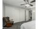 Bedroom featuring a ceiling fan, closet with sliding doors, and view into the en suite bathroom at 12703 W Shadow Hills Dr, Sun City West, AZ 85375