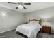 A traditional bedroom has neutral walls, carpet, and a wood bed with a bedside table at 12703 W Shadow Hills Dr, Sun City West, AZ 85375