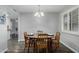 Dining room with natural light, a wooden table set for four, and shuttered windows at 12703 W Shadow Hills Dr, Sun City West, AZ 85375