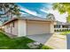 Home's exterior showcases an attached garage, manicured lawn, and neat landscaping at 12703 W Shadow Hills Dr, Sun City West, AZ 85375