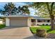 Charming single-story home with a two-car garage, mature trees, and well-maintained landscaping at 12703 W Shadow Hills Dr, Sun City West, AZ 85375