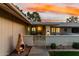 Inviting front porch featuring a decorative gate, brick accents, a chiminea, and outdoor seating at 12703 W Shadow Hills Dr, Sun City West, AZ 85375