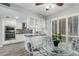 Bright eat-in kitchen features white cabinets, granite countertops, and stainless steel appliances at 12703 W Shadow Hills Dr, Sun City West, AZ 85375