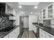Stylish kitchen featuring granite countertops, stainless steel appliances, and open layout to the dining area at 12703 W Shadow Hills Dr, Sun City West, AZ 85375