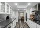 Modern kitchen with granite countertops, subway tile backsplash, stainless appliances, and ample storage at 12703 W Shadow Hills Dr, Sun City West, AZ 85375