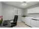 Laundry room featuring a desk, cabinets, and a stacked washer and dryer at 12703 W Shadow Hills Dr, Sun City West, AZ 85375