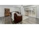 Comfortable living room with leather sofas, ceiling fan, and sliding glass doors to the outside patio at 12703 W Shadow Hills Dr, Sun City West, AZ 85375