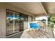 Relaxing covered patio with comfortable seating and sliding glass doors for indoor-outdoor living at 12703 W Shadow Hills Dr, Sun City West, AZ 85375