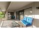 Cozy covered patio featuring comfortable seating and sliding glass door access to the interior at 12703 W Shadow Hills Dr, Sun City West, AZ 85375
