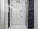 The glass enclosed shower features black and white tiles with built in shelves at 12703 W Shadow Hills Dr, Sun City West, AZ 85375