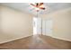 Bedroom featuring carpeted floors, ceiling fan, and closet, enhancing comfort and functionality at 15331 W Roma Ave, Goodyear, AZ 85395