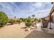 A beautiful backyard with lush landscaping and a patio area with comfortable seating at 15642 W Arbor Trl, Surprise, AZ 85374