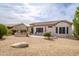 Large backyard with drought-resistant landscaping and comfortable outdoor seating area and patio at 15642 W Arbor Trl, Surprise, AZ 85374