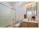 Bright bathroom featuring large mirror, updated vanity, and glass shower doors at 15642 W Arbor Trl, Surprise, AZ 85374