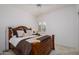 Bedroom with cozy bed, wooden headboard and shuttered window at 15642 W Arbor Trl, Surprise, AZ 85374