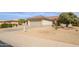 Charming home with a two-car garage, low-maintenance desert landscaping, and mailbox at 15642 W Arbor Trl, Surprise, AZ 85374