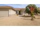 Exterior shot of home, featuring desert landscaping, a two-car garage, and neutral paint at 15642 W Arbor Trl, Surprise, AZ 85374