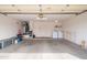 Spacious two car garage featuring laundry area, shelving, and door to outside at 15642 W Arbor Trl, Surprise, AZ 85374