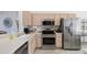 Well-lit kitchen with stainless steel appliances, neutral cabinetry, and a functional layout at 15642 W Arbor Trl, Surprise, AZ 85374