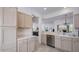Bright kitchen featuring stainless steel appliances, tile floors and view of living space at 15642 W Arbor Trl, Surprise, AZ 85374