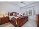 Cozy main bedroom featuring a large window, ceiling fan, and an ensuite bathroom at 15642 W Arbor Trl, Surprise, AZ 85374