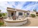 Outdoor patio area with seating, landscaping, and a view of the lush backyard at 15642 W Arbor Trl, Surprise, AZ 85374