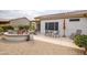 Backyard patio with seating and table for entertaining with drought-resistant landscaping at 15642 W Arbor Trl, Surprise, AZ 85374