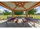 Inside view of a park picnic shelter with tables, offering shade and space for outdoor gatherings at 16018 W Shangri La Rd, Surprise, AZ 85379