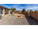 Backyard features a charming fire pit and desert landscaping, perfect for relaxing evenings at 16035 N 159Th Dr, Surprise, AZ 85374