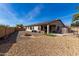 Spacious backyard featuring a built-in fire pit, low-maintenance desert landscaping, and a covered patio area at 16035 N 159Th Dr, Surprise, AZ 85374