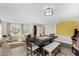 Bright dining area with modern lighting, table, and adjacent living space at 16035 N 159Th Dr, Surprise, AZ 85374