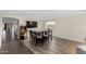 Open-concept dining room with laminate flooring, an arcade game, and a large TV screen at 16035 N 159Th Dr, Surprise, AZ 85374
