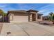 Inviting single-story home featuring a desert landscape and a two-car garage at 16035 N 159Th Dr, Surprise, AZ 85374
