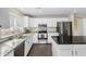 Modern kitchen featuring white cabinetry, stainless steel appliances, and granite countertops at 16035 N 159Th Dr, Surprise, AZ 85374