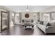 Sunlit living room featuring tile floors, neutral decor, and a sliding glass door to the backyard at 16035 N 159Th Dr, Surprise, AZ 85374