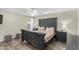 Serene main bedroom with wood-look floors, neutral colors, and ample natural light at 16035 N 159Th Dr, Surprise, AZ 85374