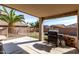 Covered patio features an outdoor kitchen area, perfect for entertaining guests, and a well-maintained backyard at 16035 N 159Th Dr, Surprise, AZ 85374