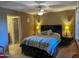 Comfortable bedroom with a plaid comforter, ceiling fan and a connected bathroom at 16657 E Gunsight Dr # 182, Fountain Hills, AZ 85268