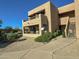 Neutral colored 2-story condo building with a patio and balcony, surrounded by low maintenance landscaping at 16657 E Gunsight Dr # 182, Fountain Hills, AZ 85268