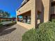 Exterior view of a stucco home with greenery and seating on the covered balcony at 16657 E Gunsight Dr # 182, Fountain Hills, AZ 85268