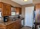 A functional kitchen with a stainless-steel sink and appliances with wood cabinets at 16657 E Gunsight Dr # 182, Fountain Hills, AZ 85268
