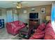 A cozy living room with carpet, 2 red sofas and a ceiling fan at 16657 E Gunsight Dr # 182, Fountain Hills, AZ 85268