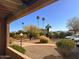 Balcony view of a beautifully landscaped yard with palm trees and parking at 16657 E Gunsight Dr # 182, Fountain Hills, AZ 85268