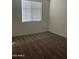Bright bedroom with a neutral color palette, plush carpet, and natural light streaming through the window at 17622 W Missouri Ave, Litchfield Park, AZ 85340