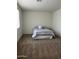 Cozy bedroom featuring a queen-sized bed with neutral linens, carpeting, and ample natural light at 17622 W Missouri Ave, Litchfield Park, AZ 85340