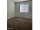 Bright bedroom featuring carpeting, neutral paint, and a window at 17622 W Missouri Ave, Litchfield Park, AZ 85340