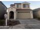 Two-story home with a two-car garage, stucco siding, and a red tile roof at 17622 W Missouri Ave, Litchfield Park, AZ 85340
